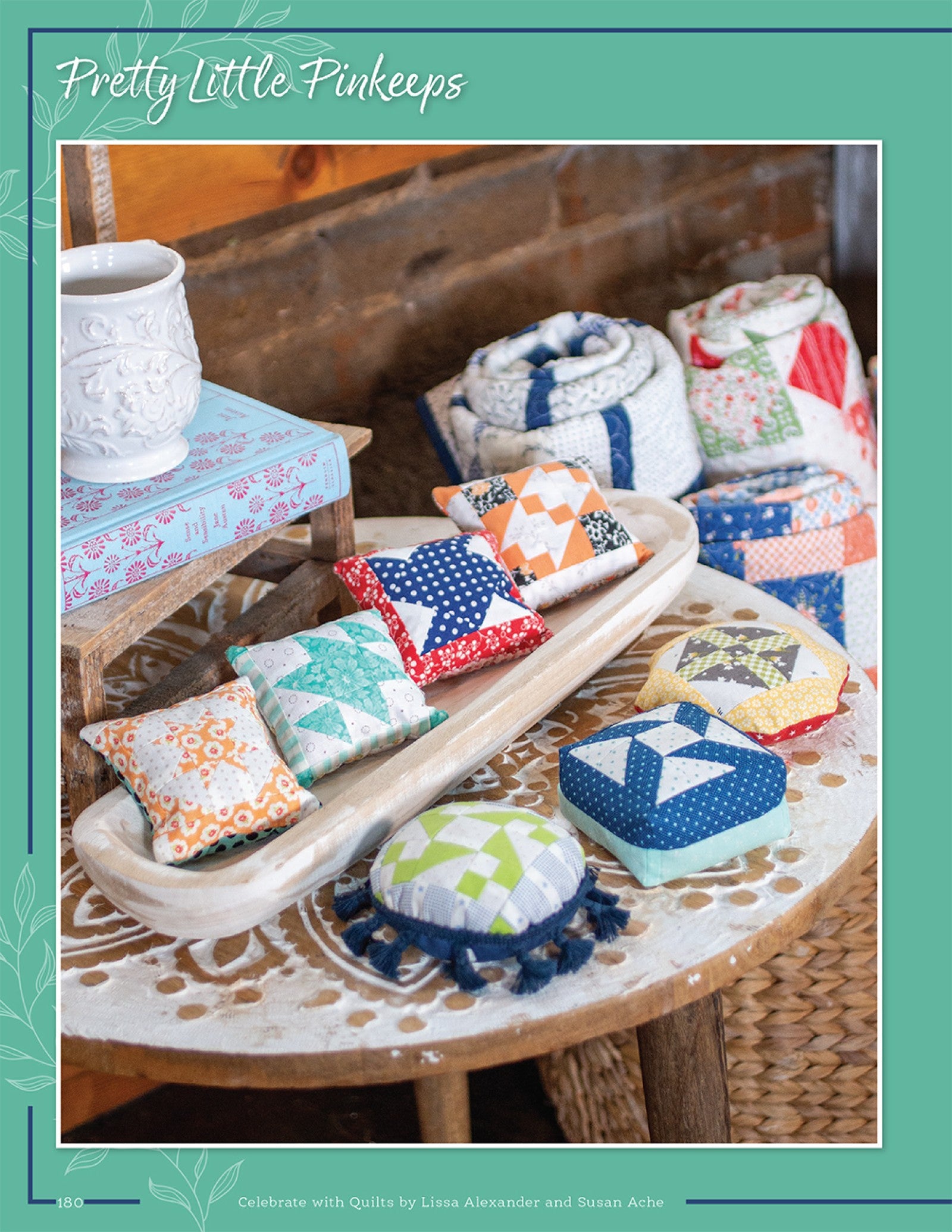 Pretty Little Pinkeeps from Celebrate With Quilts, a set of small pieced pincushions on a table.