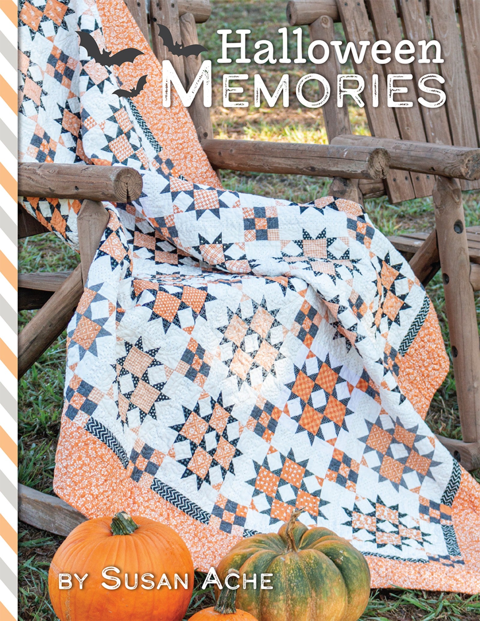 Front cover of Halloween Memories Quilt and Cross Stitch Pattern Book by Susan Ache for It's Sew Emma, showing an orange, cream, and grey Halloween quilt draped over a chair with pumpkins.