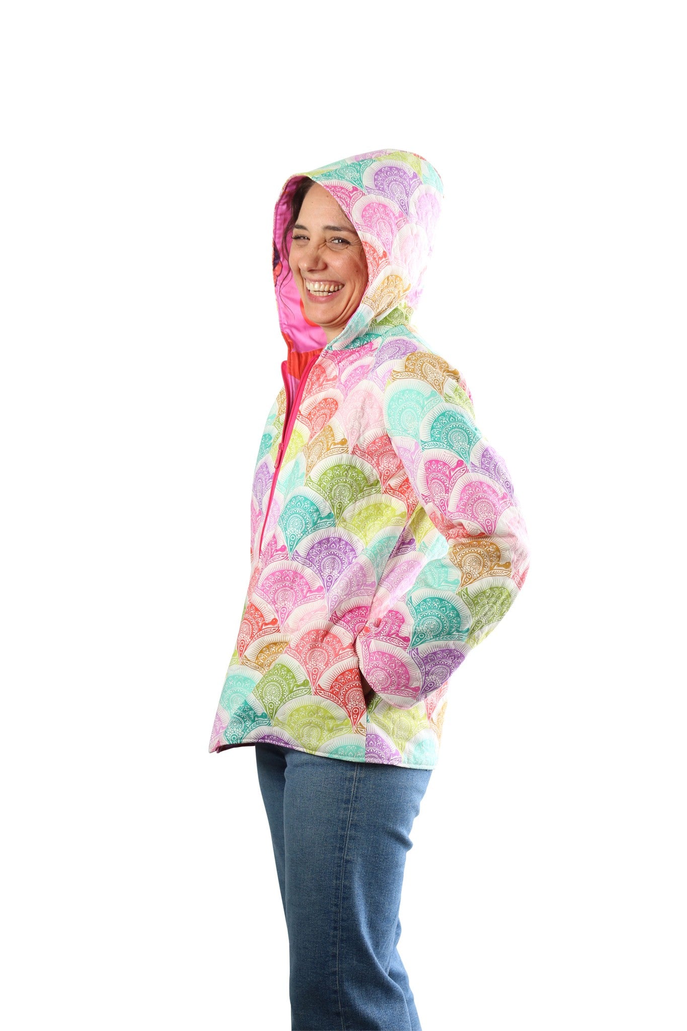 Side view of a person wearing a Bella Quilt Coat with the hood up in a soft pastel scallop print.