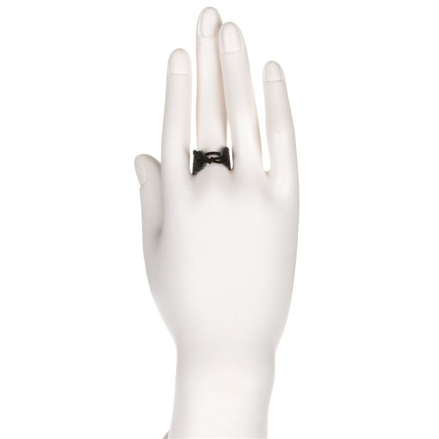 Back of the white display hand, showing the thin black cord tied across the back of the middle finger to hold the Olympus leather thimble in place.
