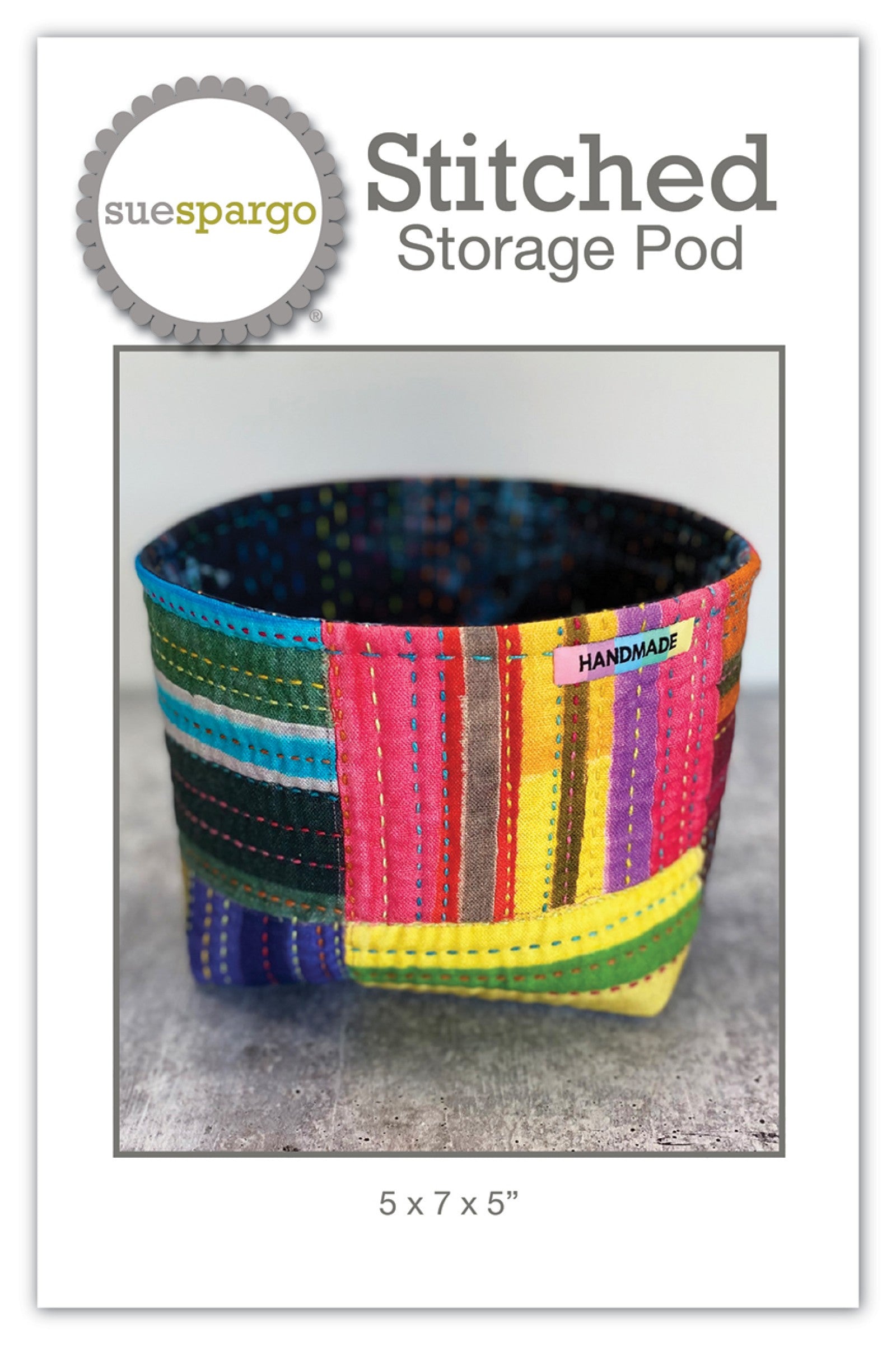 Stitched Storage Pod sewing pattern by Sue Spargo of Folk Art Quilts. Front cover shows the finished open fabric pod made from panels of brightly striped cotton covered in rows of colorful big-stitch hand embroidery, with a pink HANDMADE label and a dark print lining. Finished size 5 by 7 by 5 inches shown.