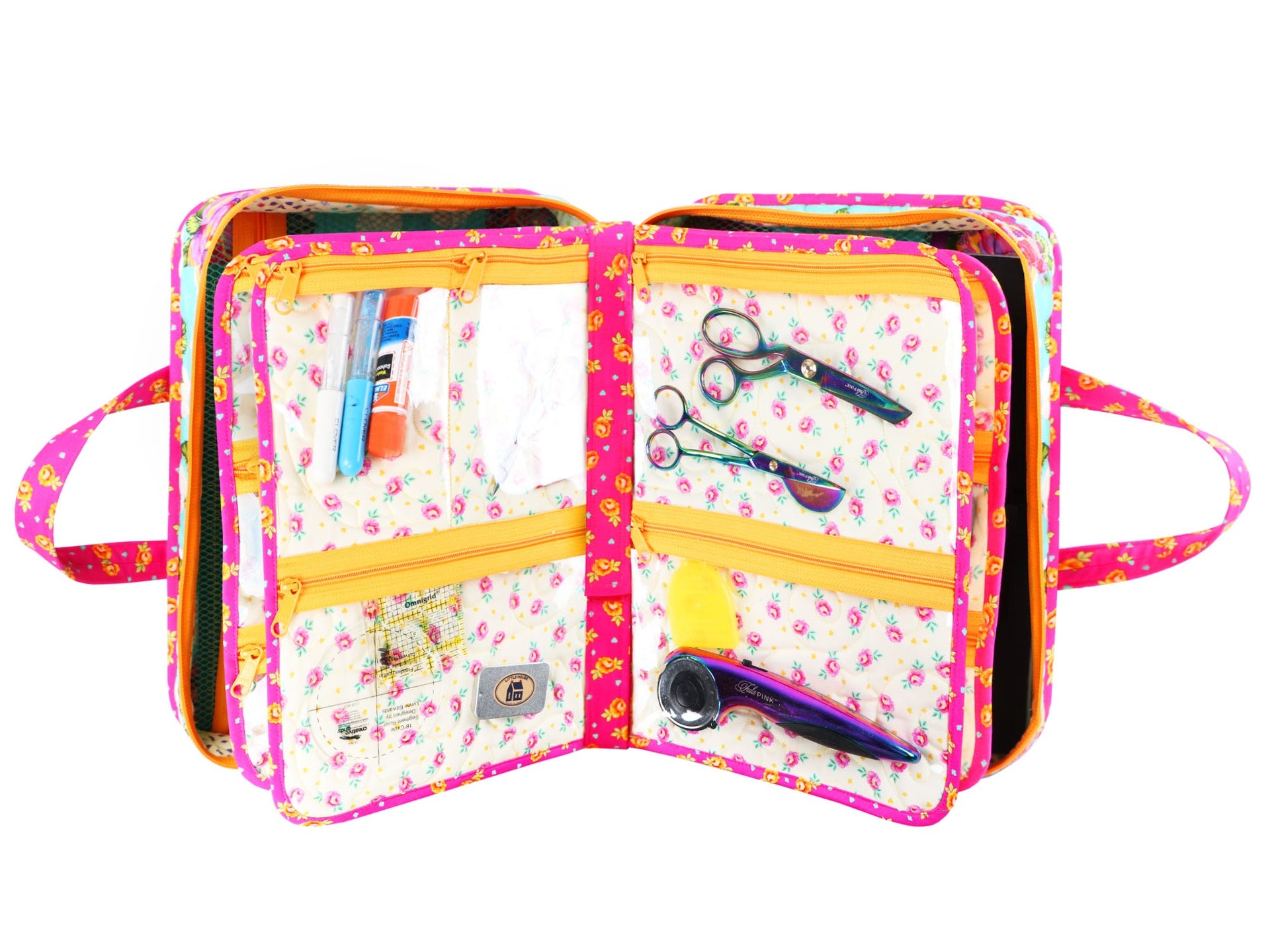 An A Place for Everything organizer opened flat, showing the removable pages with sewing notions and scissors in the pockets.