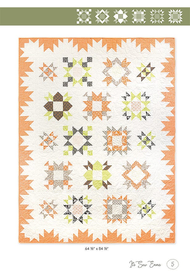 Full view of the Among the Stars Again sampler quilt in the autumn Harvest colorway, star blocks in oranges, greens, and browns inside an orange sawtooth border.