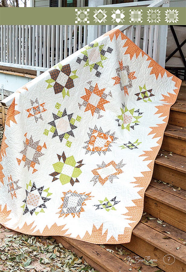 Among the Stars Again sampler quilt in the Harvest colorway draped over wooden porch steps outdoors.