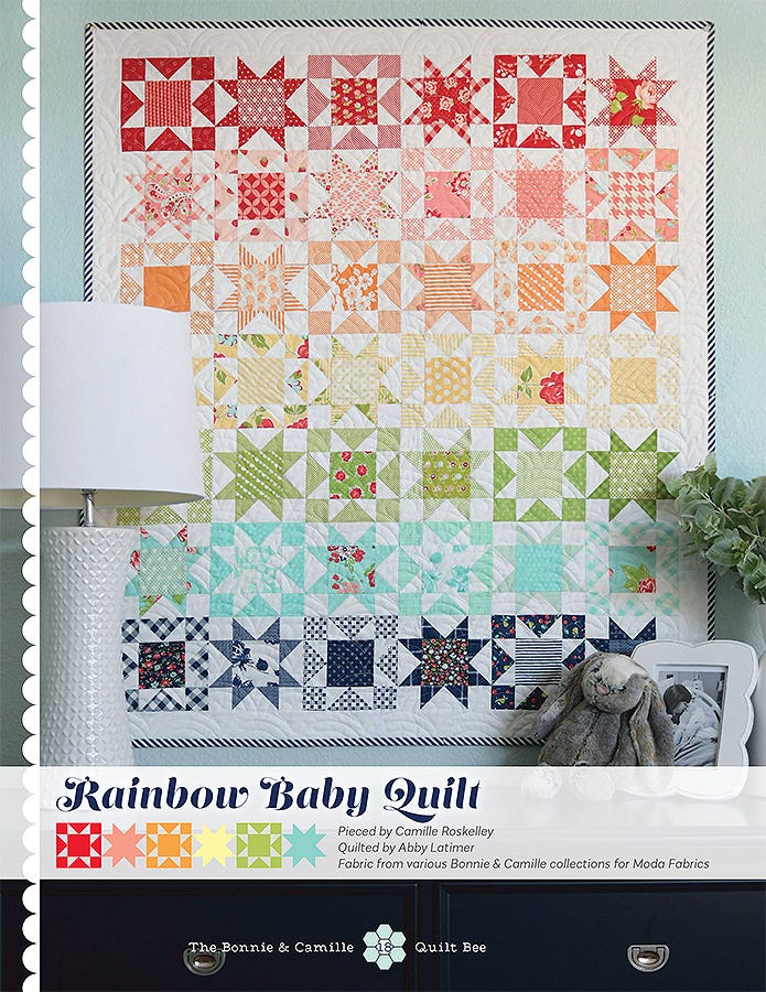 Rainbow Baby Quilt from The Bonnie & Camille Quilt Bee, a grid of small star blocks in soft rainbow prints on white.