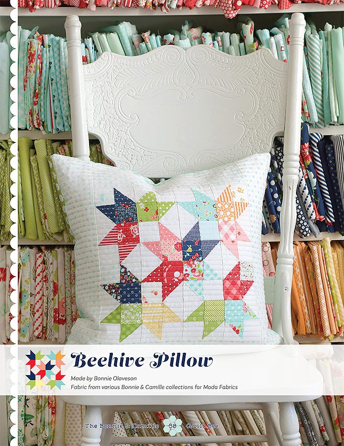 Beehive Pillow from The Bonnie & Camille Quilt Bee, a pieced star pillow in navy, red, and cream.