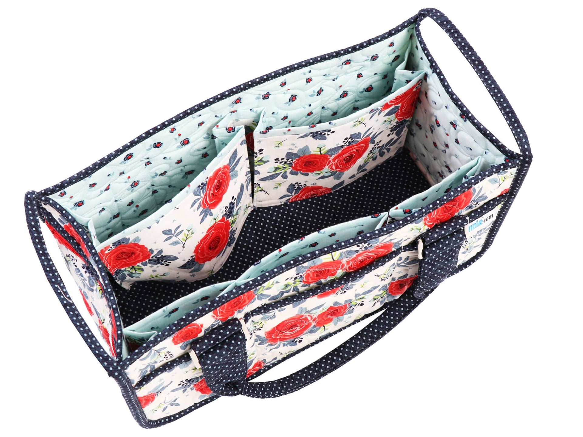 Top-down view inside the Catch All Caddy 2.0 in the navy rose print, showing the expanding interior dividers separating the center compartment from the lined side pockets.