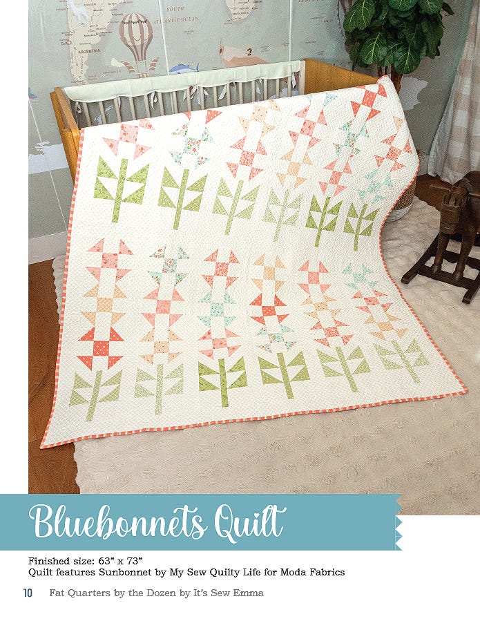The Bluebonnets quilt, 63 x 73 inches, rows of pieced flower stems in soft prints on a cream background, draped over a crib.