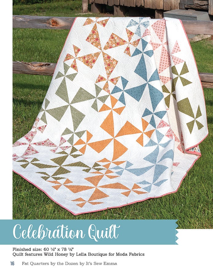 The Celebration quilt, 60.5 x 78.5 inches, pieced pinwheel bursts in orange, green, and blue on white, shown outdoors.