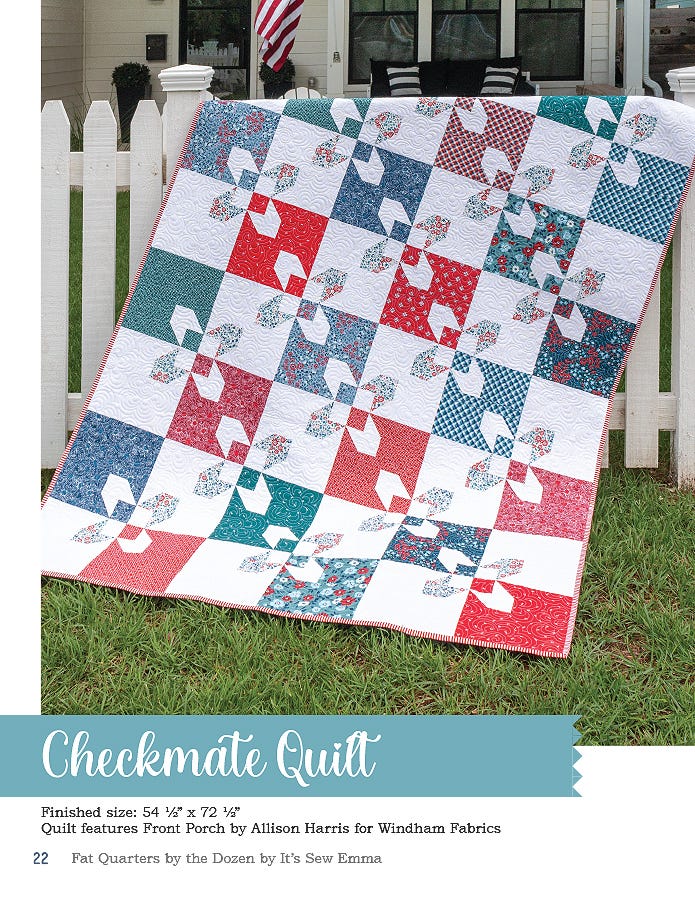 The Checkmate quilt, 54.5 x 72.5 inches, a red, white, and blue patchwork of squares and shoo-fly blocks by a picket fence.