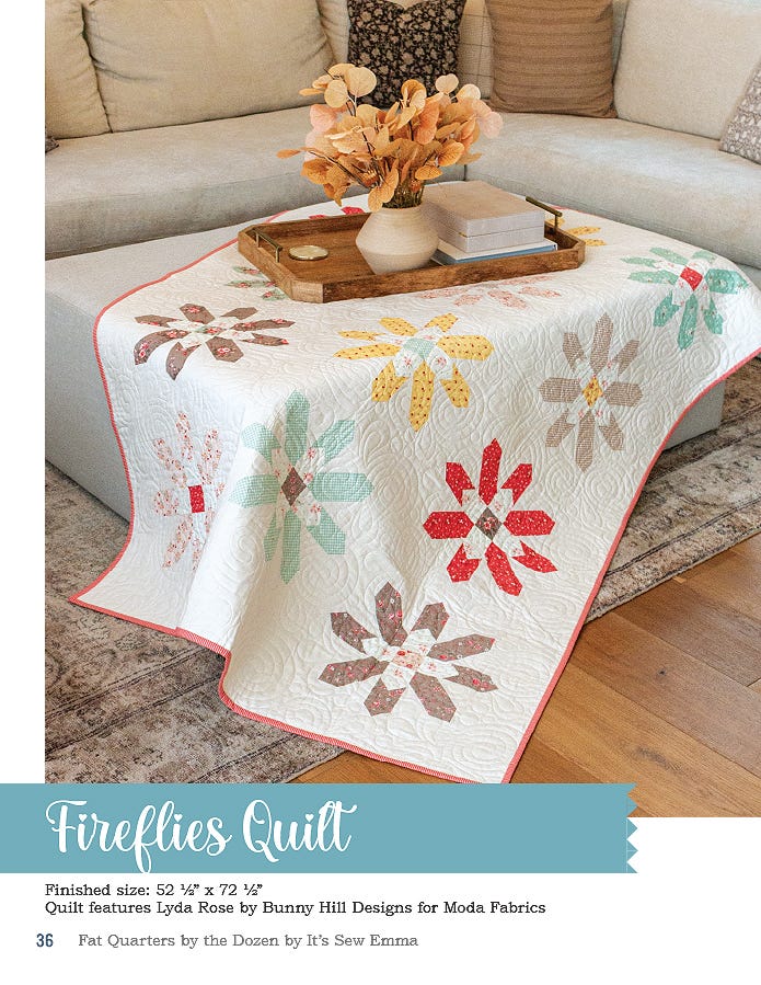 The Fireflies quilt, 52.5 x 72.5 inches, pieced flower blocks in muted prints on cream, draped over a sofa table.