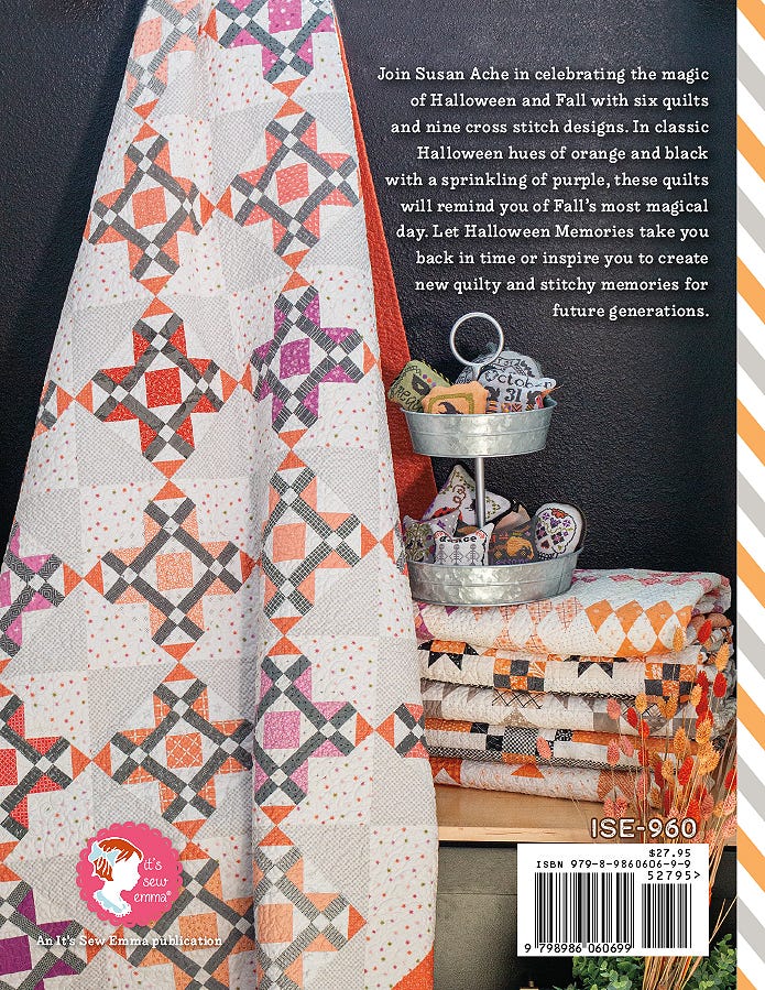 Back cover of Halloween Memories by Susan Ache for It's Sew Emma, describing six quilts and nine cross stitch designs, with a styled photo of stitched pieces and item number ISE-960.