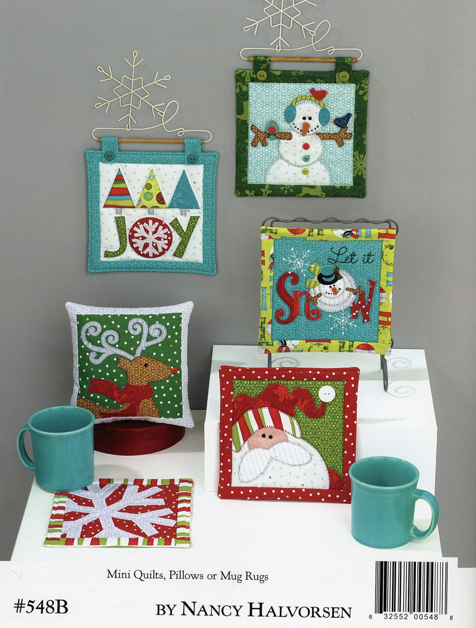 Back cover of the Ho Ho Ho Let It Snow quilt pattern book by Nancy Halvorsen of Art to Heart, showing mini quilts, pillows, and mug rugs with appliqued snowmen and snowflakes. Marked number 548B by Nancy Halvorsen.