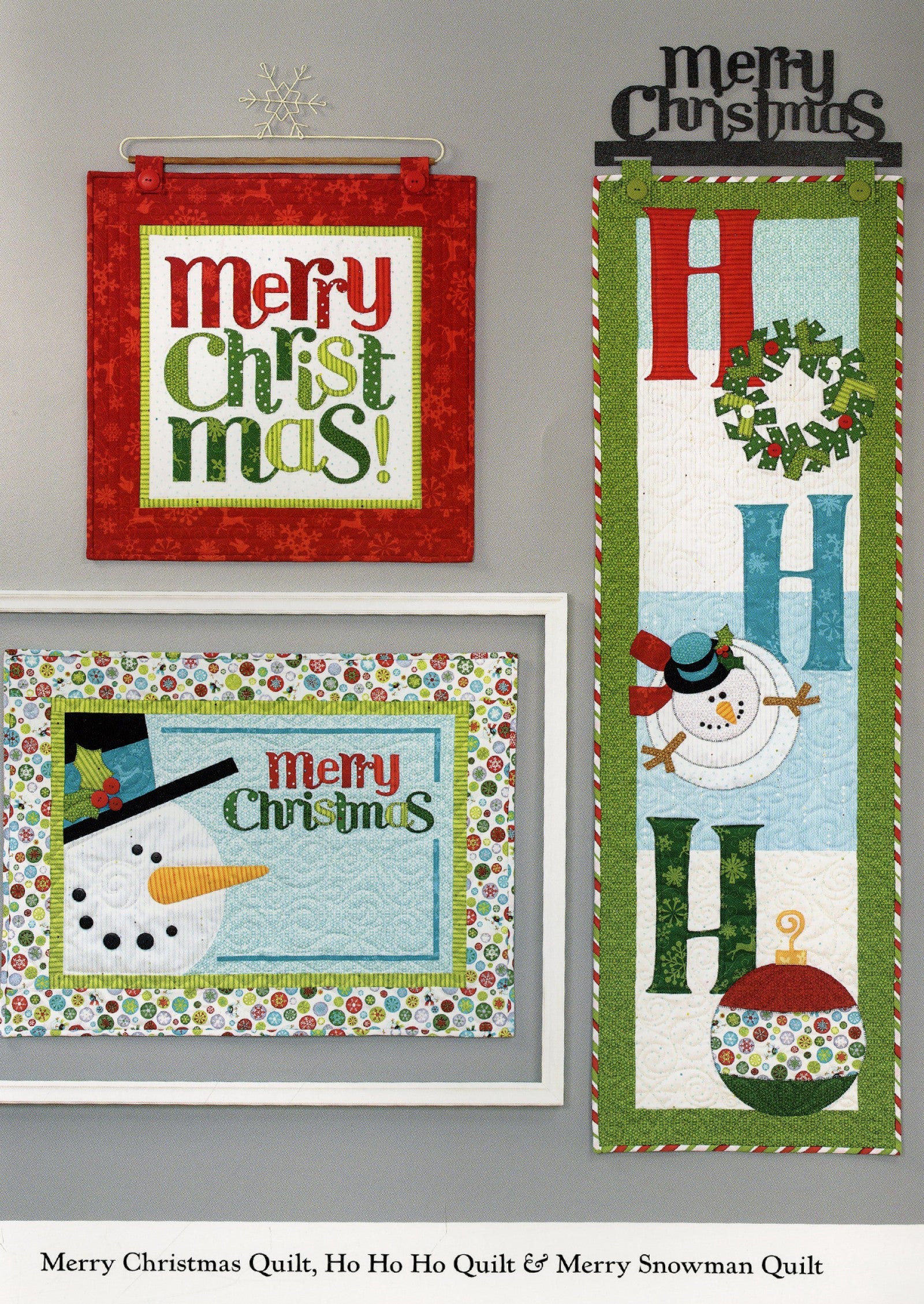 Interior page of the Ho Ho Ho Let It Snow quilt pattern book by Nancy Halvorsen of Art to Heart, showing the Merry Christmas, Ho Ho Ho, and Merry Snowman quilts with appliqued lettering and snowmen.