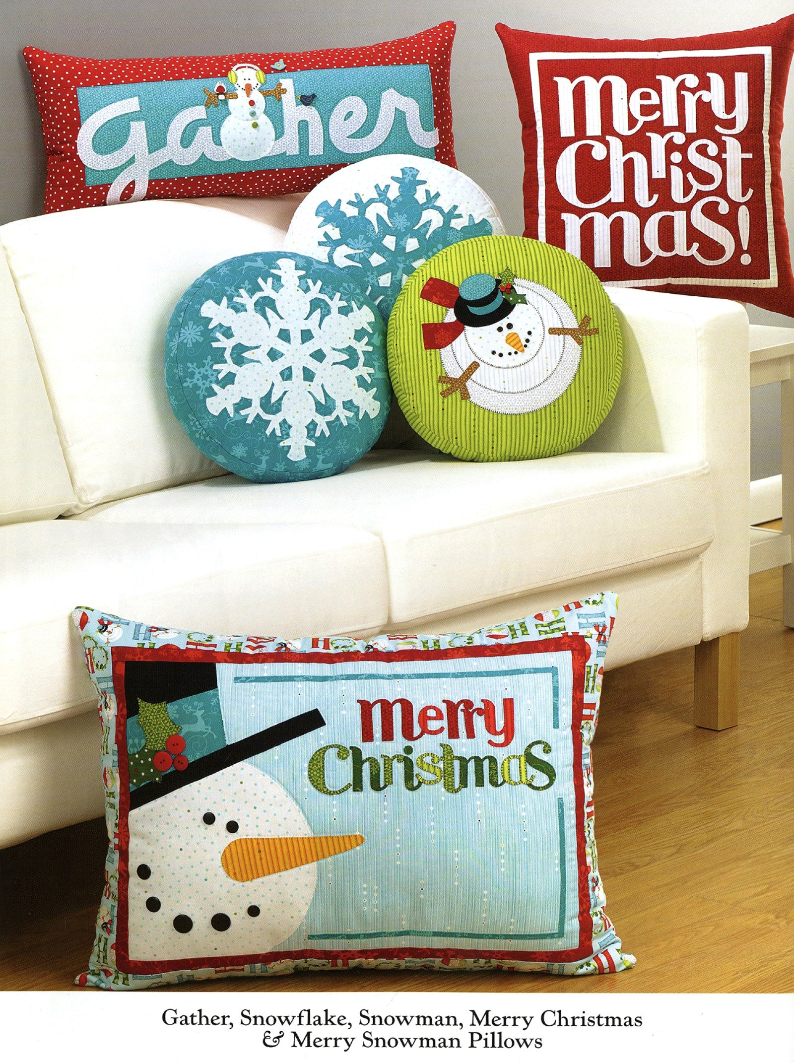 Interior page of the Ho Ho Ho Let It Snow quilt pattern book by Nancy Halvorsen of Art to Heart, showing Gather, Snowflake, Snowman, and Merry Christmas pillows in winter colors.