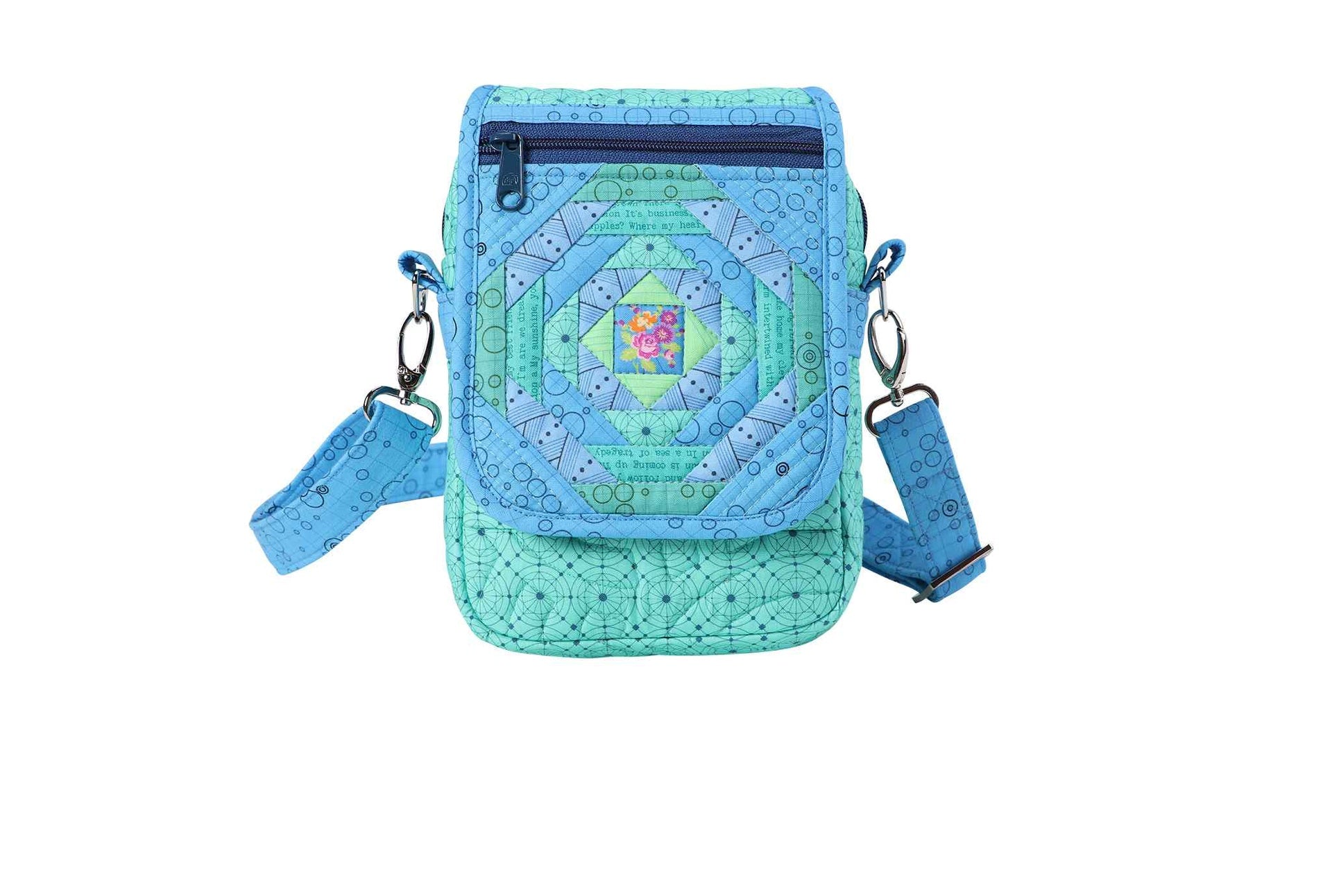 A finished On the Go bag in a teal print, shown from the front with the crossbody strap attached and a top zipper.
