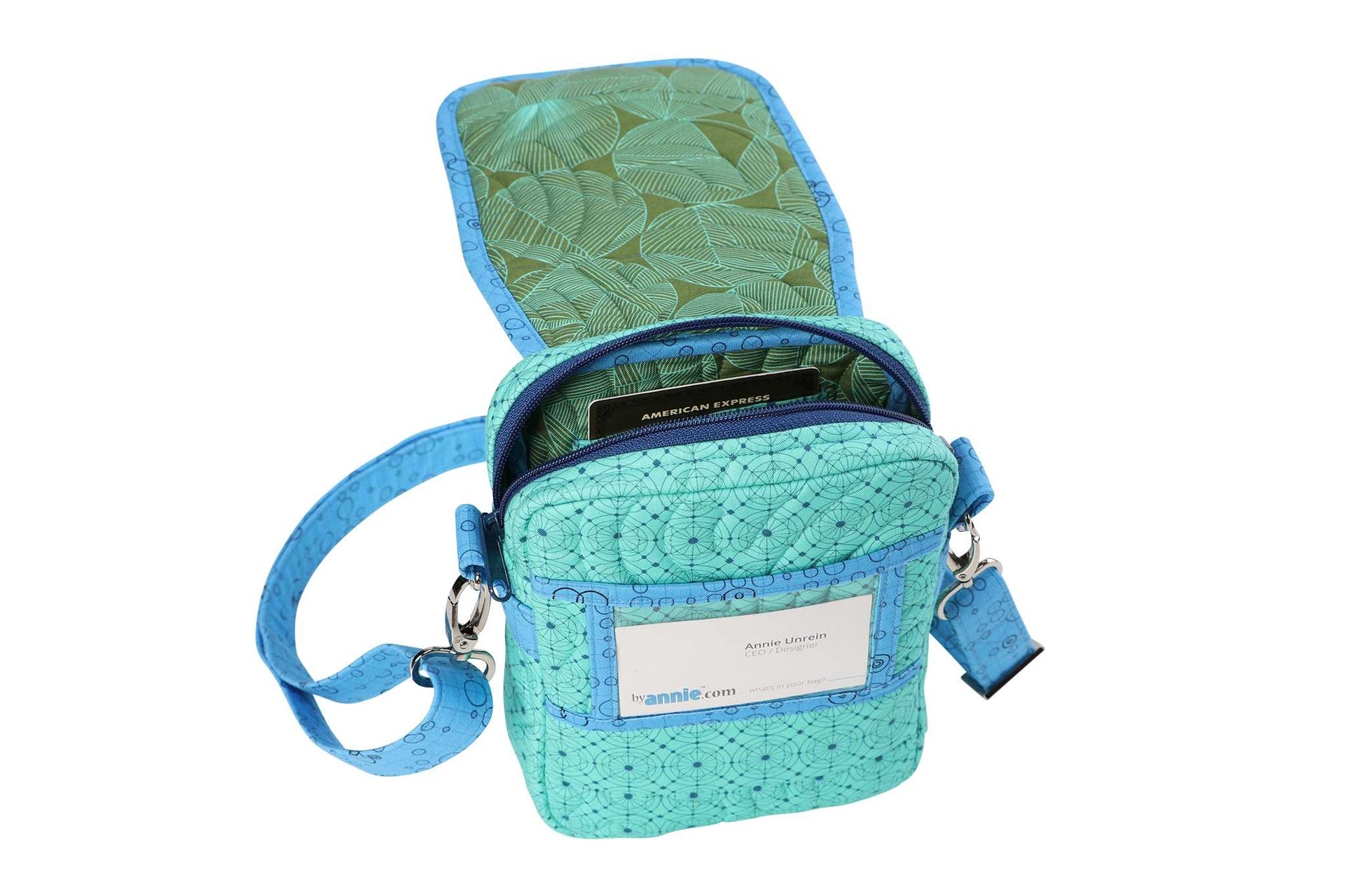 The On the Go bag in teal shown open, showing the interior compartment, credit card pockets, and a clear ID window.