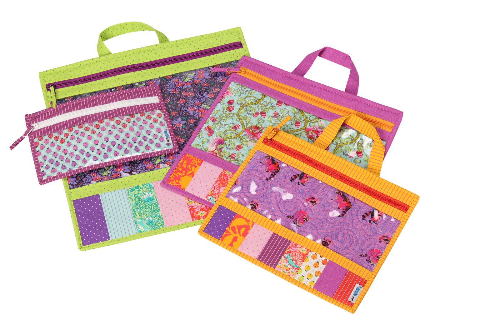 A set of Project Bags with clear vinyl fronts and bright bindings, fanned out to show quilting fabric and projects visible inside.