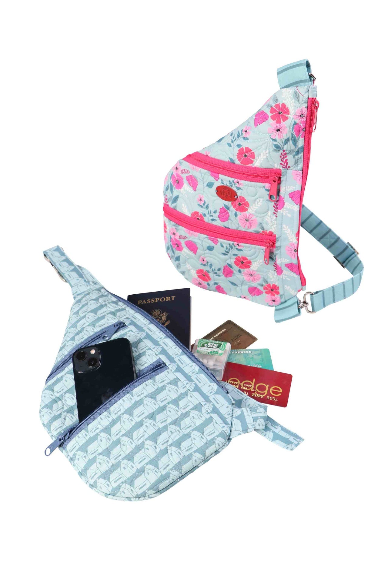 A Side Hustle sling bag with its front zippered pockets open, holding a phone and cards.