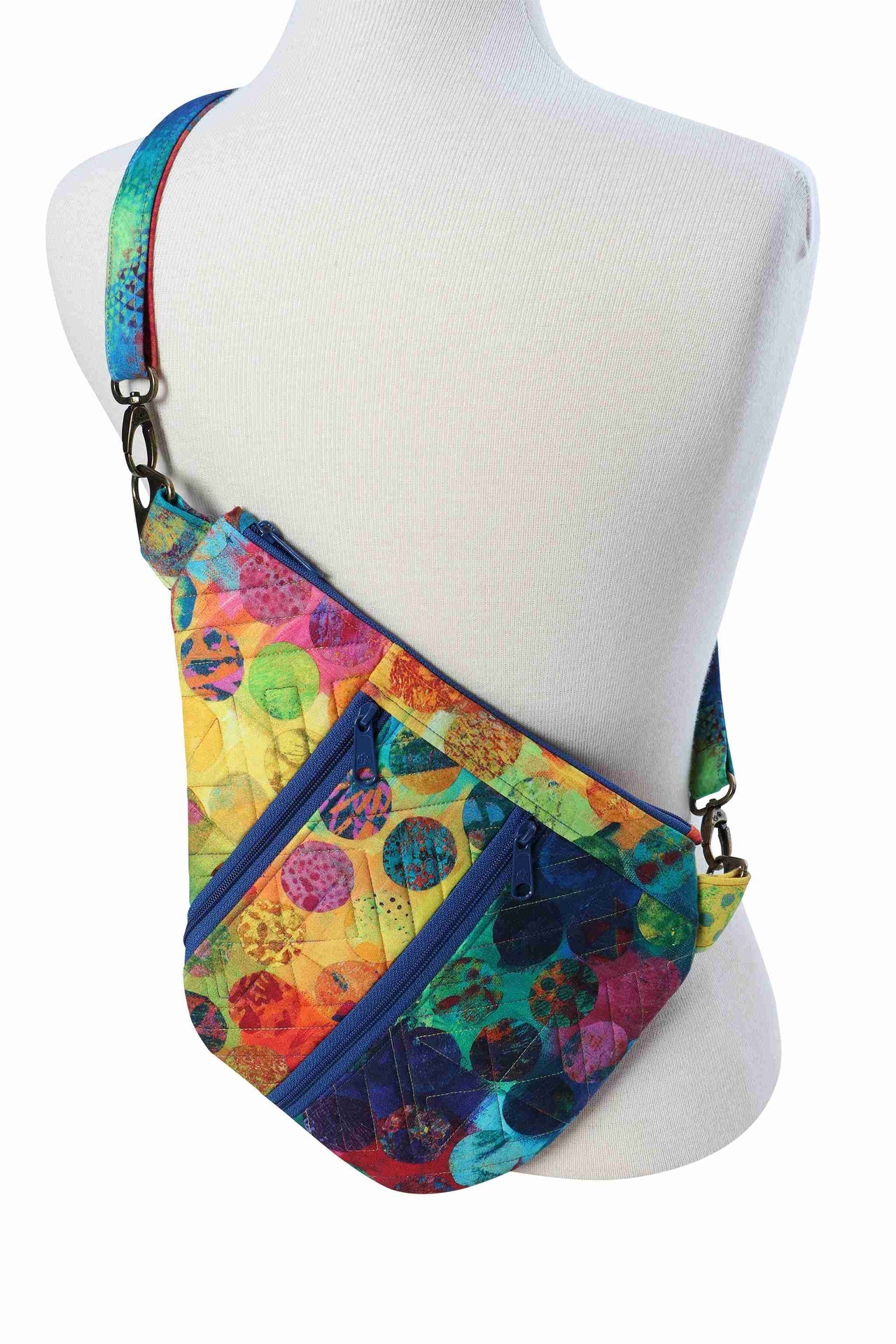 A Side Hustle sling bag worn crossbody on a form, sitting close to the body.