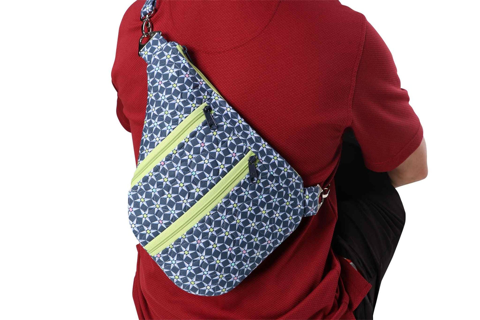 A person wearing a Side Hustle sling bag crossbody over one shoulder.